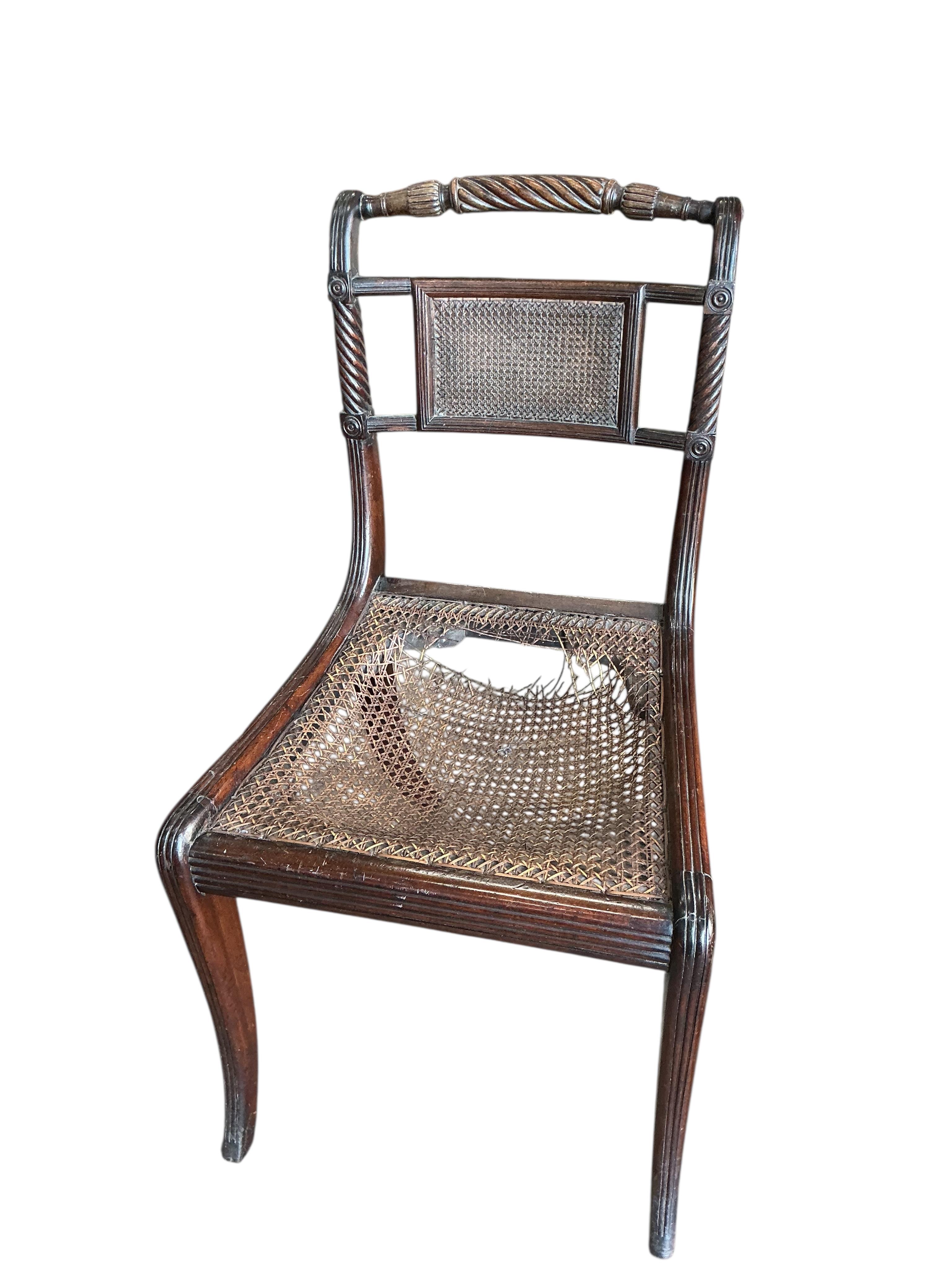 A Hepplewhite style painted mahogany elbow chair and a Regency cane seated single chair and a George III Provincial elm chair